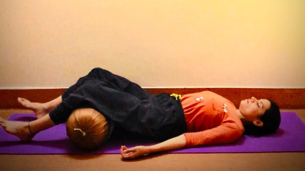 Savasana With Bolster Under Knees